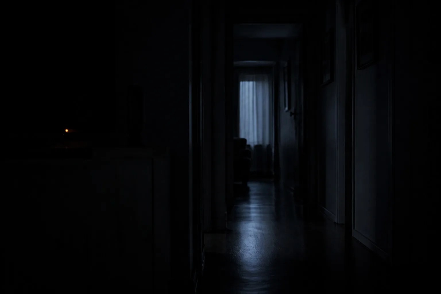 A dark hallway with every indicator light dimmed except one small amber standby LED